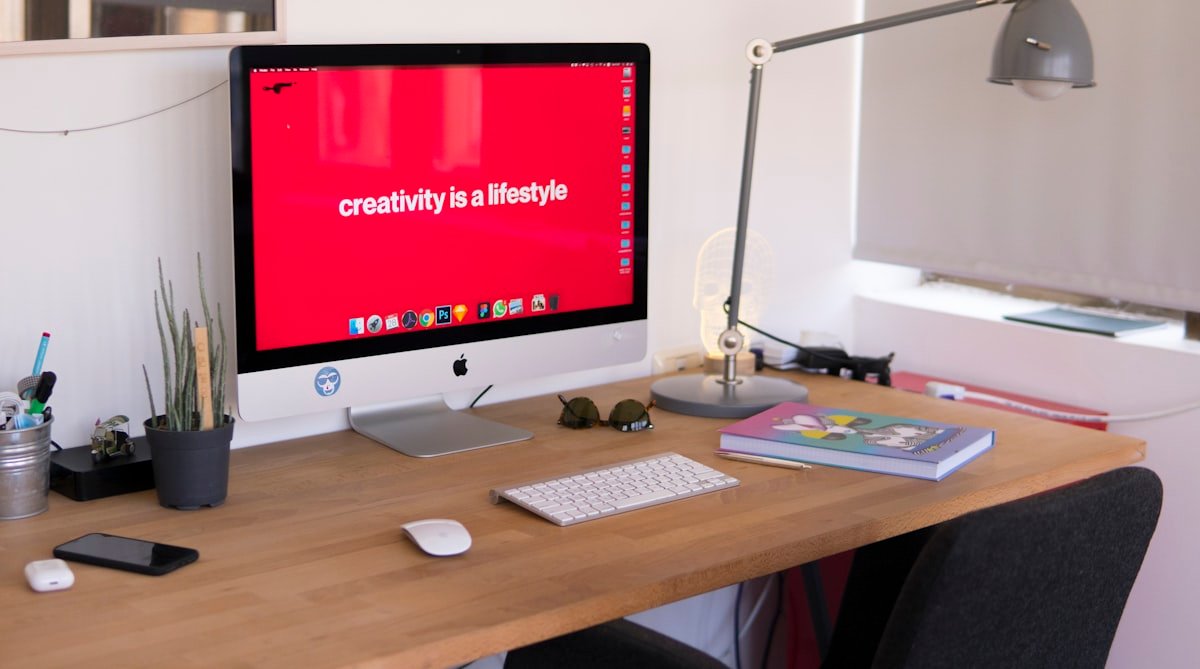 Creative studio desk with design software running